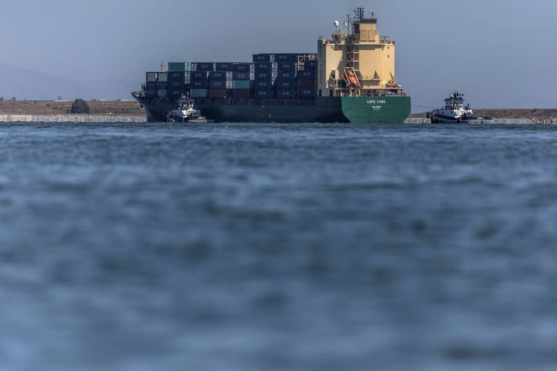 A cargo ship arrives at the port of Oakland, California