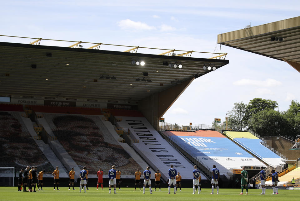 Players observe a minute of silence in memory of Jack Charlton prior to the start of the English Premier League soccer match between Watford and Everton at the Molineux Stadium in Wolverhampton, England, Sunday, July 12, 2020. (Molly Darlington/Pool via AP)