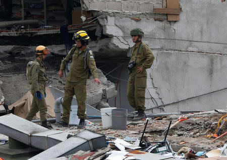 Israeli rescue team members search for survivors in the rubble of a collapsed building after an earthquake in Mexico City, Mexico, September 21, 2017. REUTERS/Henry Romero