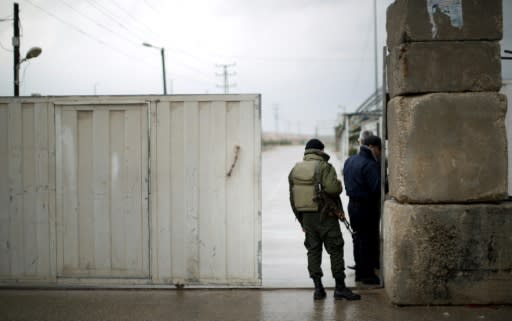 Palestinian Hamas security forces stand at the Palestinian side of the Erez pedestrian crossing with Israel after it was closed on March 13, 2014