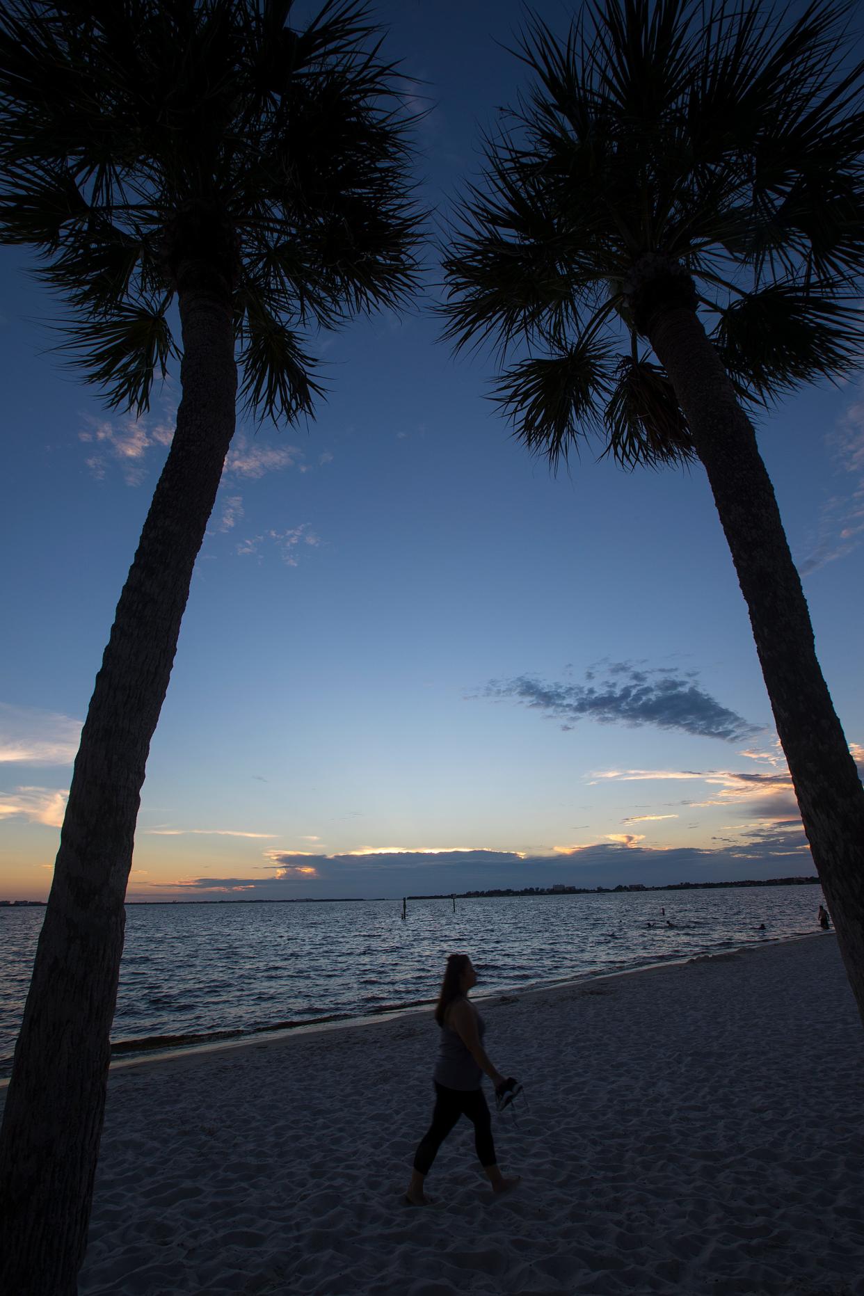 A visitor to the Cape Coral Yacht Club enjoys a serene sunset there in October 2018.