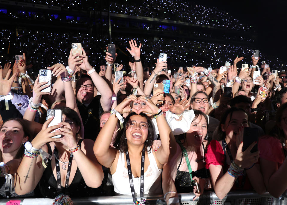PARIS, FRANCE - MAY 10: (EDITORIAL USE ONLY. NO BOOK COVERS.) Fans watch Taylor Swift perform onstage during night two of 