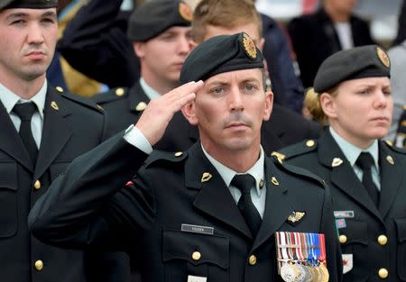 A soldier salutes as the casket passes following the funeral service for Cpl. Nathan Cirillo in Hamilton, Ontario October 28 2014. REUTERS/Aaron Harris