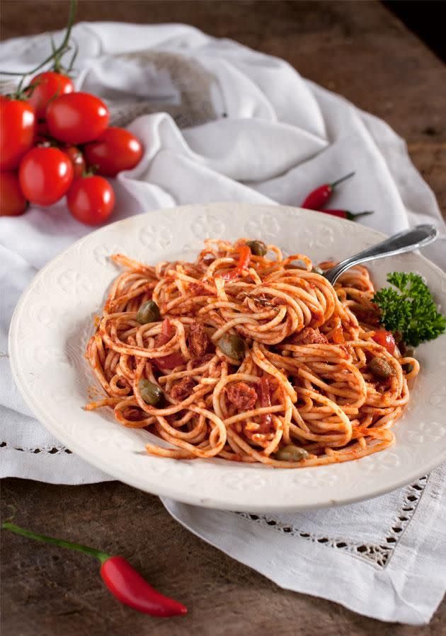 Spaghetti with tomato, preserved tuna, capers and anchovies. Photo: Getty Images