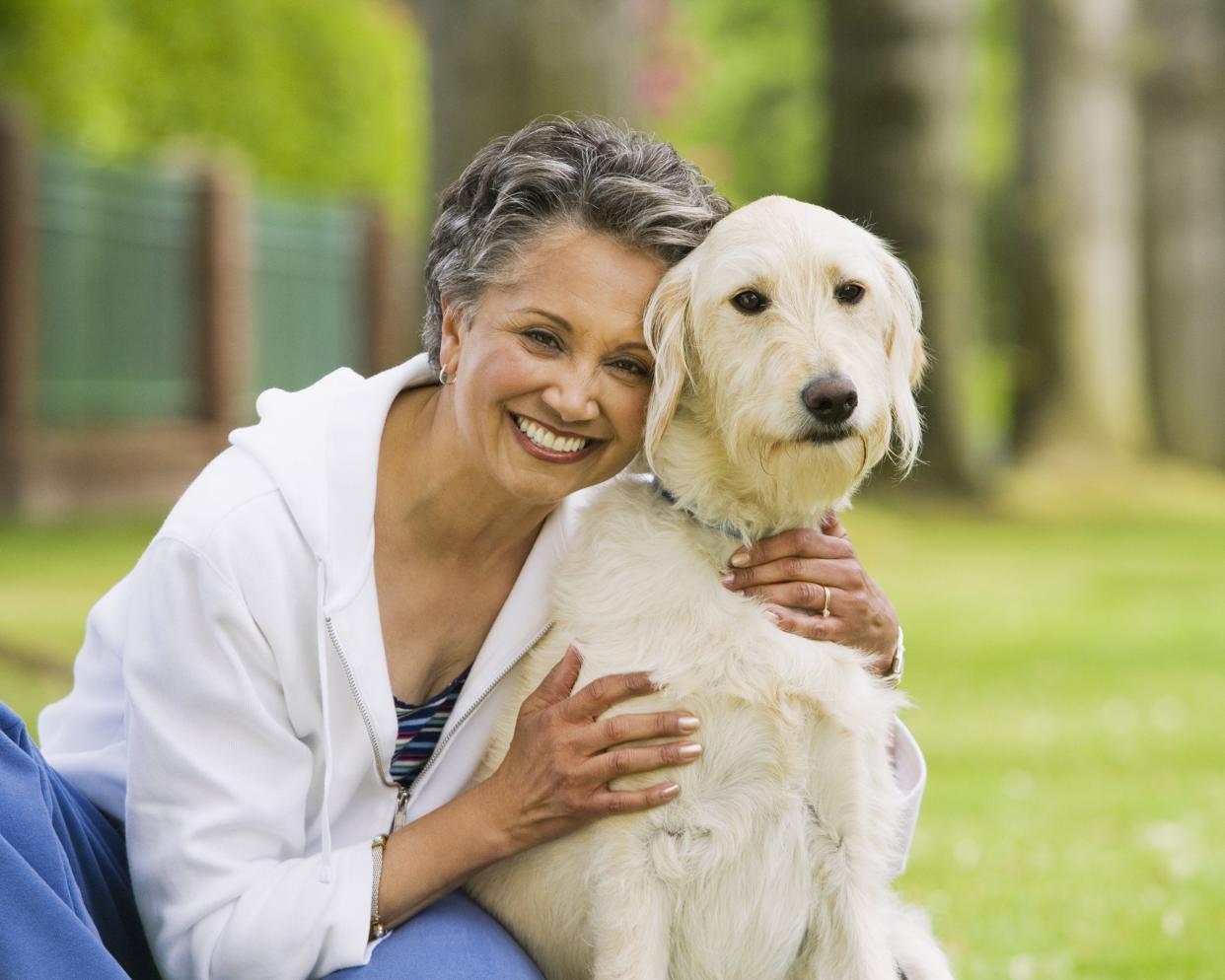 African American woman hugging dog