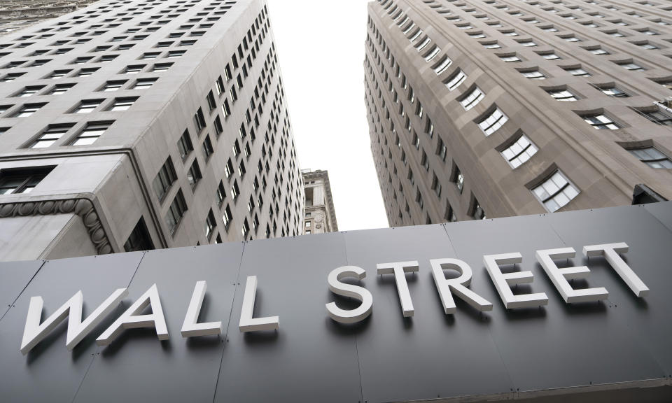 FILE - In this Aug. 31, 2020 file photo, buildings line Wall Street, in New York. Stocks are ticking higher in early Wednesday, Sept. 16, trading on Wall Street, ahead of a decision on interest-rate policy by the Federal Reserve scheduled for the afternoon. (AP Photo/Mark Lennihan, File)