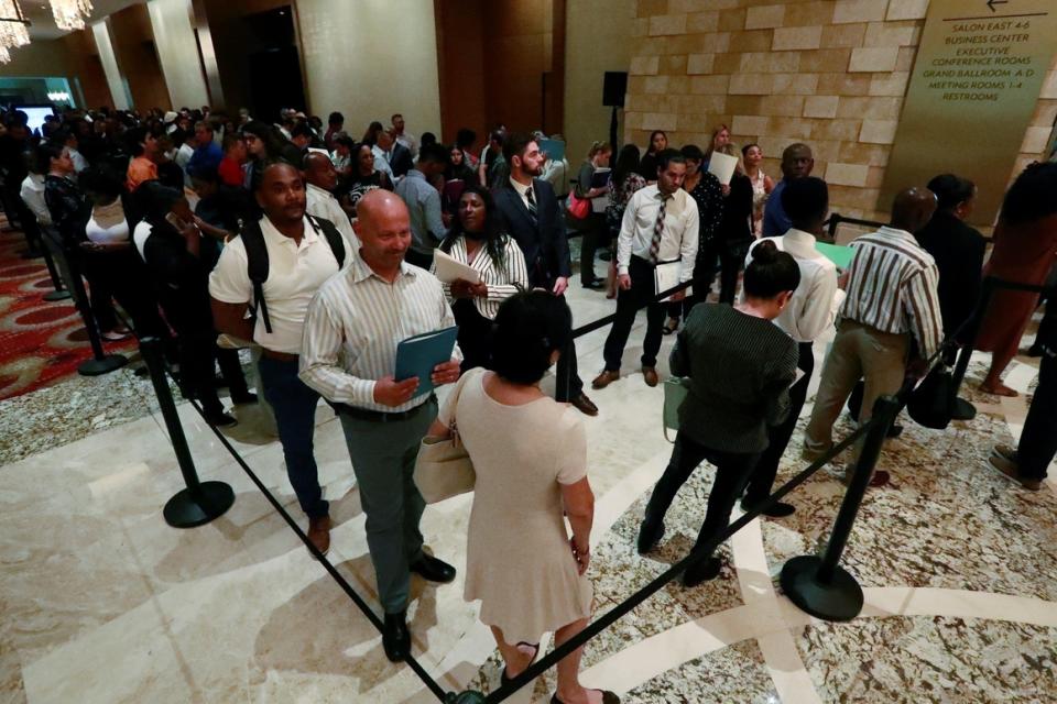 Job applicants line up June 4 during a job fair in Hollywood, Fla. Unemployment remains low at 3.6 percent but job growth has been sluggish in recent months.