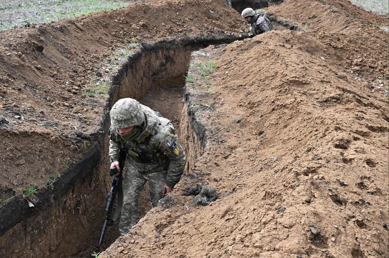 Ukrainian servicemen walks along trenches near the town of Bakhmut on Saturday (AFP/Getty)