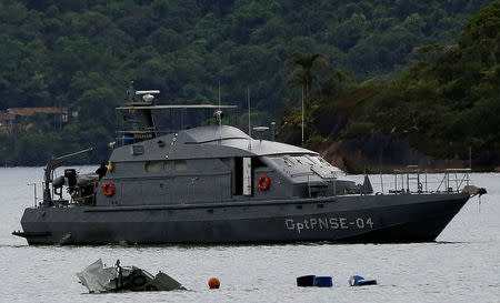 A Navy ship is seen near the wreckage from a plane, which crashed with Brazilian Supreme Court Justice Teori Zavascki, who was overseeing a graft investigation into scores of powerful politicians, in Paraty, Rio de Janeiro state, Brazil, January 20, 2017. REUTERS/Bruno Kelly