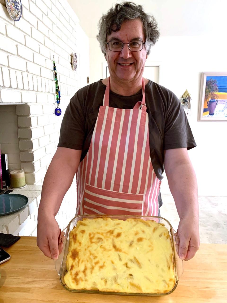 Greek dad proudly holding his pastitio pan