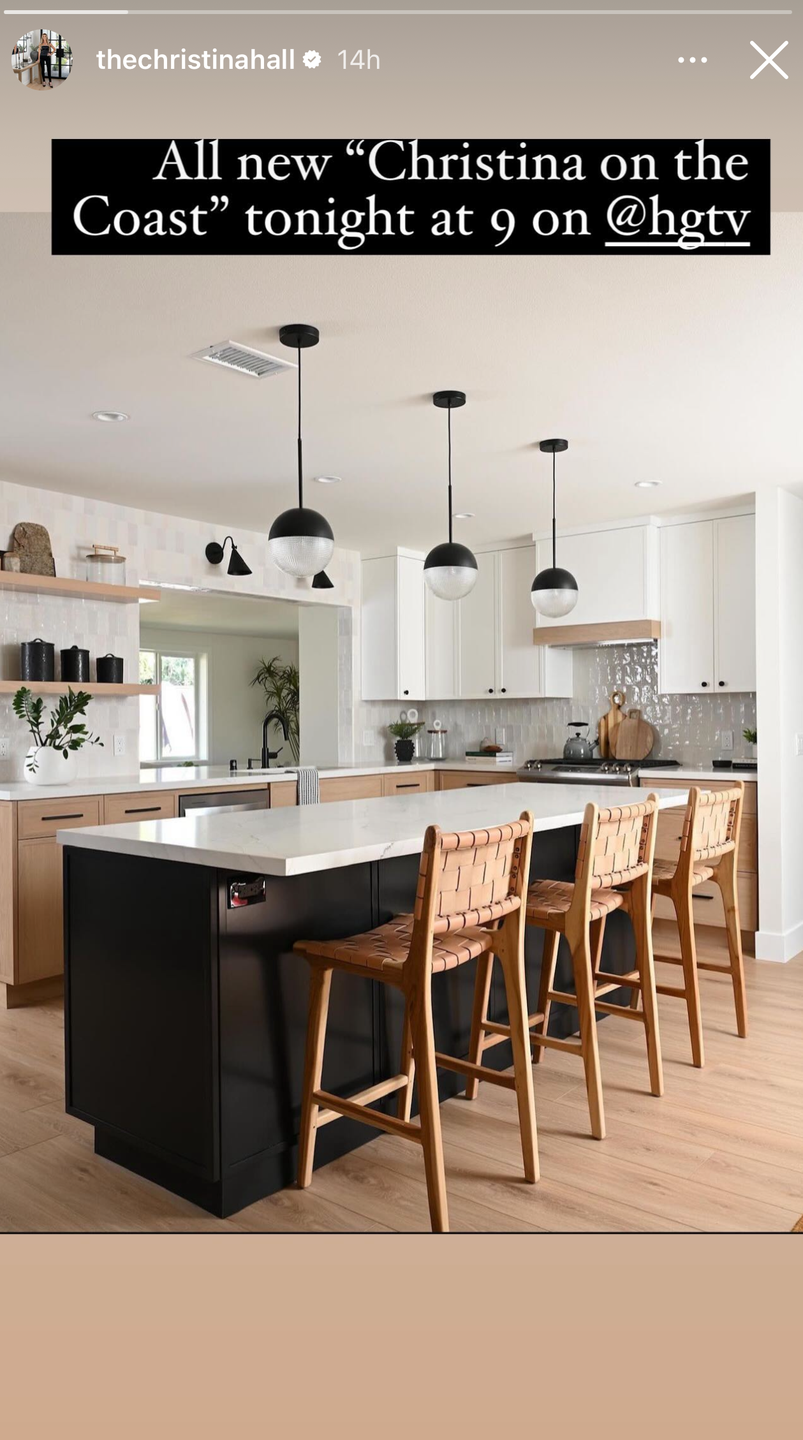 a kitchen with a bar stools and a table