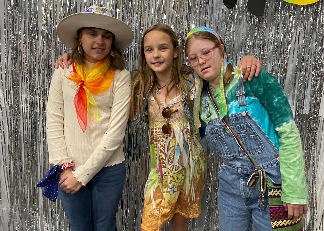 Besties Ella Watson, 12, Abriella Deja, 10, and Ellyana Olsen, 12, pause for a split second to take a photo at the Dancing Through the Decades event sponsored by Joni and Friends Nov. 11 at Fellowship Church on Middlebrook Pike.