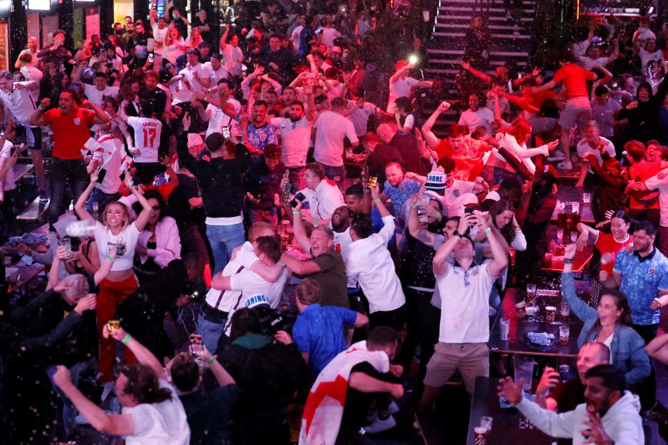 England supporters celebrate England's penalty and second goal as they watch the Euro 2020 semi-final football match between England and Denmark, at Boxpark Croydon. 