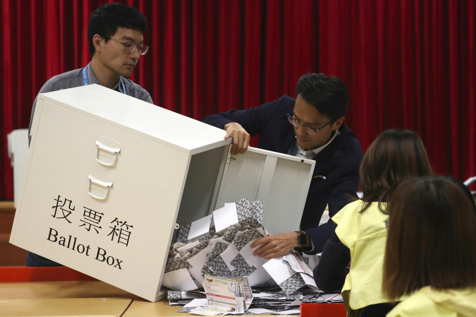 Election workers empty a ballot box to count votes at a polling station in Hong Kong, Sunday, Nov. 24, 2019. Voters in Hong Kong turned out in droves on Sunday in district council elections seen as a barometer of public support for pro-democracy protests that have rocked the semi-autonomous Chinese territory for more than five months. (AP Photo/Ng Han Guan)