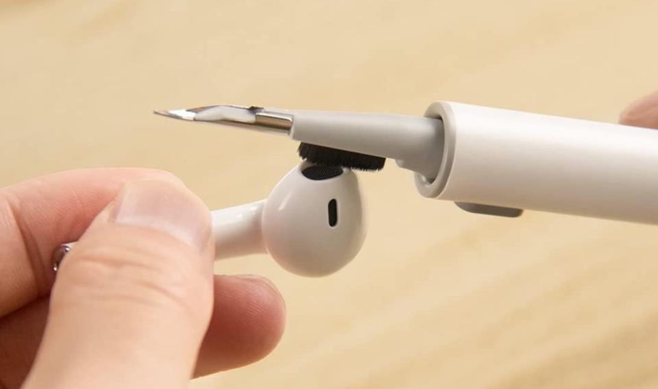 An up-close photo of the Hyashee Earbud Cleaning Kit being used on an AirPod.