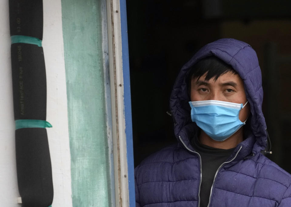 A Vietnamese worker looks on from a barrack near the northern Serbian town of Zrenjanin, 50 kilometers north of Belgrade, Serbia, Thursday, Nov. 18, 2021. Reports have emerged in Serbia of prison-like conditions for some 500 of them at the construction site in north of the country where China's Shandong Linglong Tire Co is building the huge factory. Populist-run Serbia is a key spot for China's expansion and investment policies in Europe and Chinese companies have kept a tight lid on their projects in the country amid reports of disrespect of the Balkan nation's anti-pollution laws and labor regulations. (AP Photo/Darko Vojinovic)