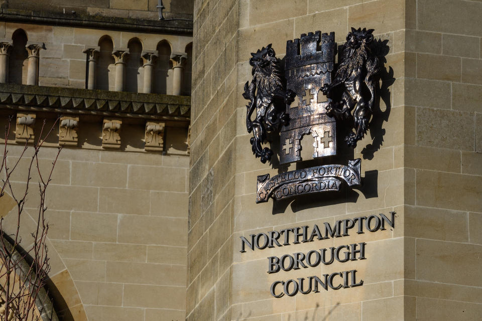 NORTHAMPTON, UNITED KINGDOM - FEBRUARY 15:  The Northampton Borough Council sign is seen on the County Hall in the town centre on February 15, 2018 in Northampton, United Kingdom.  Northamptonshire County Council has banned all new spending after announcing an overspend of £21m for the 2017-18 period. As it attempts to pay off £150m of loans, the council is looking at selling it's new £53m headquarters at One Angel Square, which was only opened in October 2017.  (Photo by Leon Neal/Getty Images)