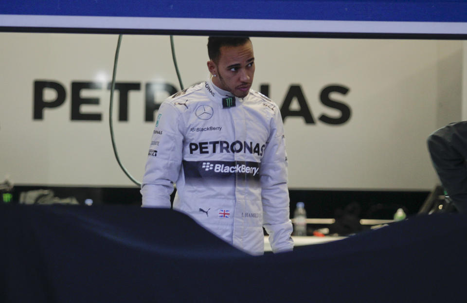 Mercedes GP driver Lewis Hamilton of Great Britain stands in a garage at the Circuito de Jerez on Tuesday, Jan. 28, 2014, in Jerez de la Frontera, Spain. (AP Photo/Miguel Angel Morenatti)