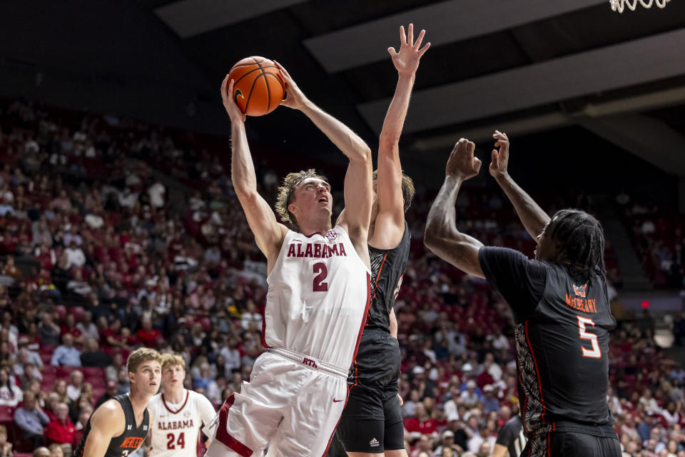 Alabama forward Grant Nelson (2) works against Mercer forward Jalyn McCreary (5) to shoot during the first half of an NCAA college basketball game, Friday, Nov. 17, 2023, in Tuscaloosa, Ala. (AP Photo/Vasha Hunt)