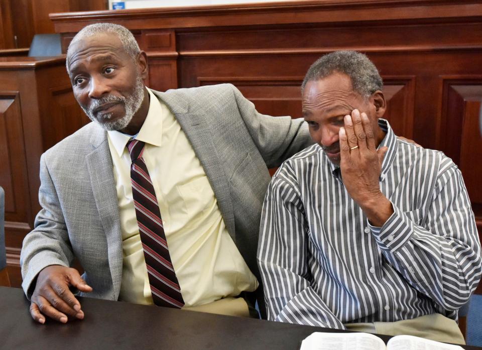 Nathan Myers, left, embraces his uncle, Clifford Williams, during a news conference after their 1976 murder convictions were overturned Thursday, March 28, 2019.