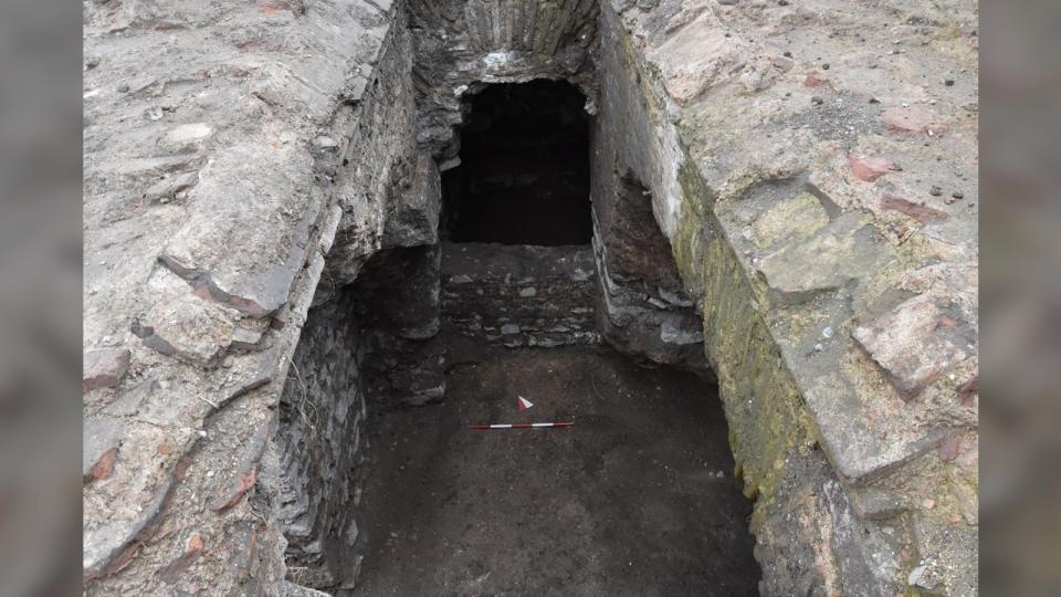 The underground chambers were reopened in March this year for a redevelopment of the derelict church ruins as an archaeological park. Here we have an above view leading down to the rectangular hole surrounded by gray stone walls.