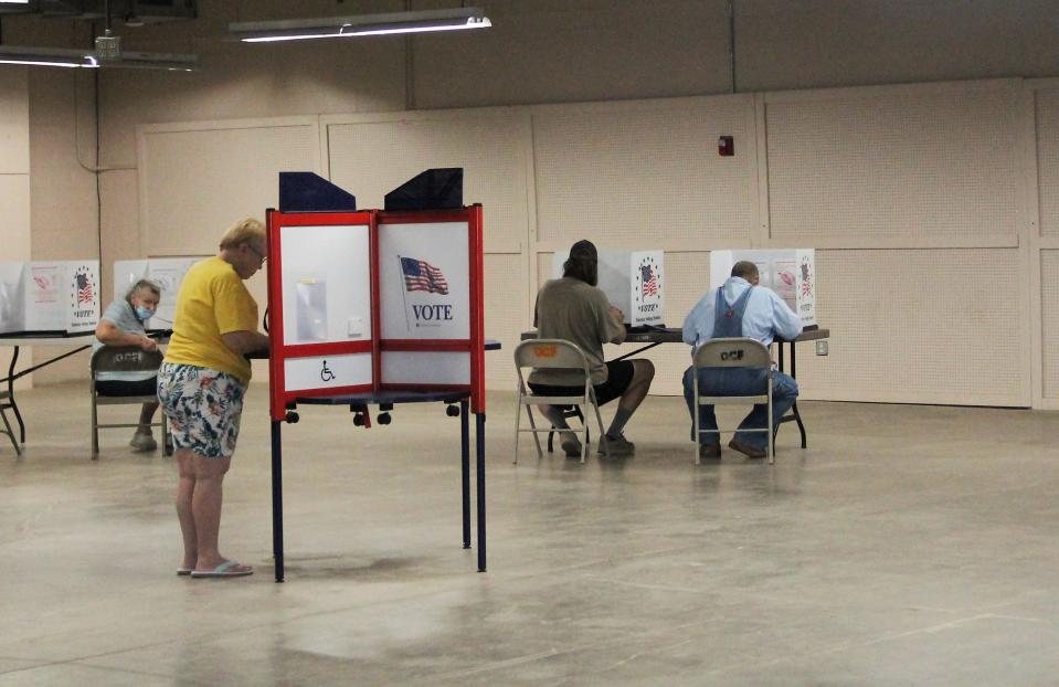 Voters fill in their ballots at the Otero County Fairgrounds on June 7, 2022.