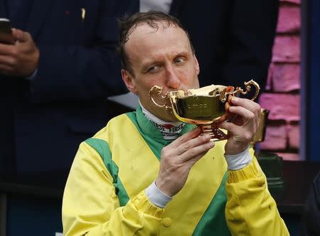 Britain Horse Racing - Cheltenham Festival - Cheltenham Racecourse - 17/3/17 Robbie Power celebrates with the trophy after winning the 3.30 Timico Cheltenham Gold Cup Chase on Sizing John Reuters / Stefan Wermuth