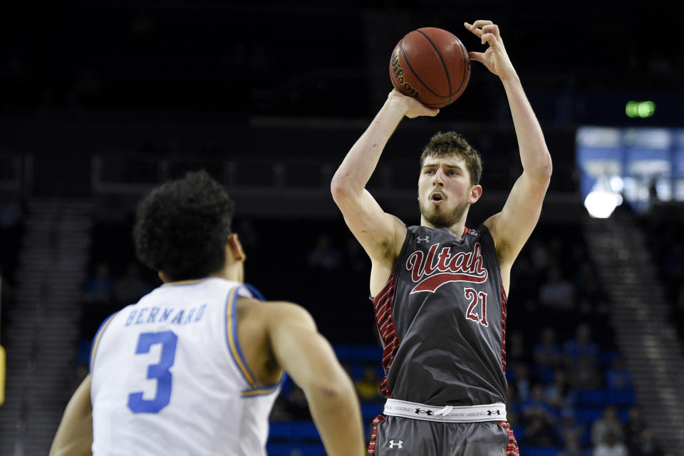 Utah forward Riley Battin, right, shoots in front of UCLA guard Jules Bernard during the second half of an NCAA college basketball game in Los Angeles, Sunday, Feb. 2, 2020. (AP Photo/Kelvin Kuo)