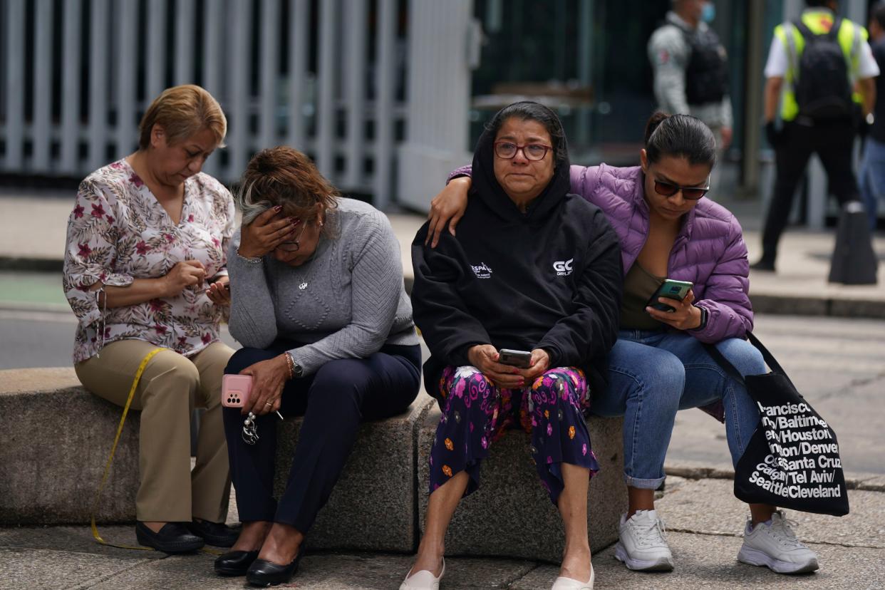 People gather outside after a magnitude 7.6 earthquake was felt in Mexico City, Monday, Sept. 19, 2022. There were no immediate reports of damage from the quake that hit at 1:05 p.m. local time, according to the U.S. Geologic Survey, which said the quake was centered near the boundary of Colima and Michoacan states. 