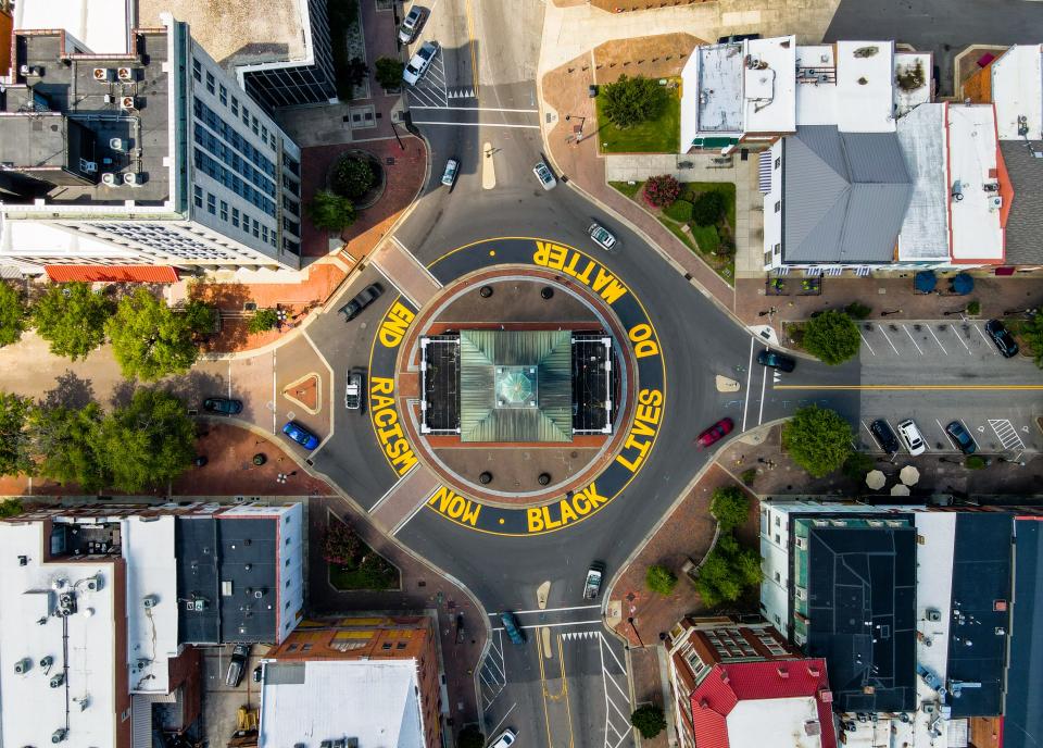 An aerial shot of “End racism now” and “Black lives do matter” painted around the Market House in downtown Fayetteville.