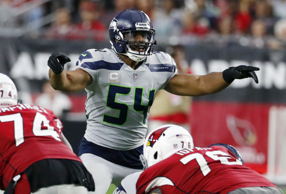 FILE - In this Sept. 30, 2018, file photo, Seattle Seahawks linebacker Bobby Wagner (54) gestures at the line of scrimmage during an NFL football game against the Arizona Cardinals in Glendale, Ariz. Seattle’s Bobby Wagner and Sean Lee of Dallas were the All-Pro leaders of their defenses at linebacker the previous time the Seahawks and Cowboys made the playoffs.Little has changed for Wagner’s group in two years. Not much is the same for the middle of the Dallas defense going into the first postseason meeting between the teams since the 2006 season.. (AP Photo/Rick Scuteri, File)