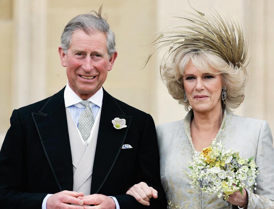 Prince Charles, and The Duchess Of Cornwall, Camilla Parker Bowles in silk dress by Robinson Valentine and head-dress by Philip Treacy, leaves the Service of Prayer and Dedication blessing their marriage at Windsor Castle on April 9, 2005 in Berkshire, England