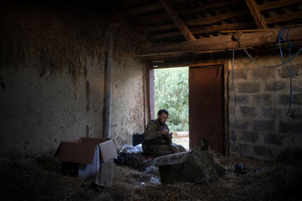 Stem, a member of the elite Ukrainian drone unit, attaches a bomb to an exploding drone in the outskirts of Kremmina, Ukraine (Copyright 2023 The Associated Press. All rights reserved)