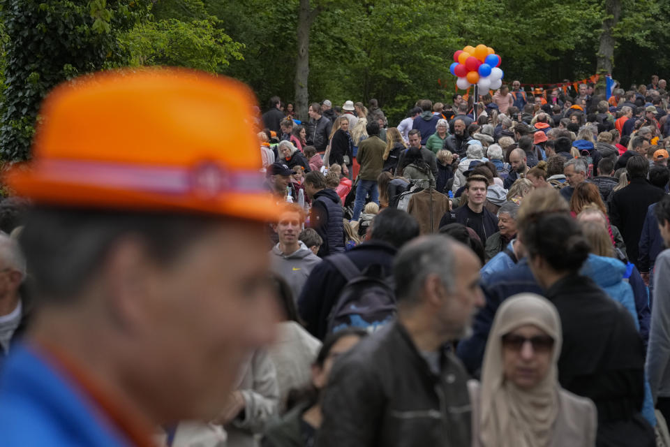 Orange-clad people celebrate King's Day in Amsterdam's Vondelpark, Netherlands, Wednesday, April 27, 2022. After two years of celebrations muted by coronavirus lockdowns, the Netherlands marked the 55th anniversary of King Willem-Alexander of the House of Orange with street parties, music festivals and a national poll showing trust in the monarch ebbing away. (AP Photo/Peter Dejong)