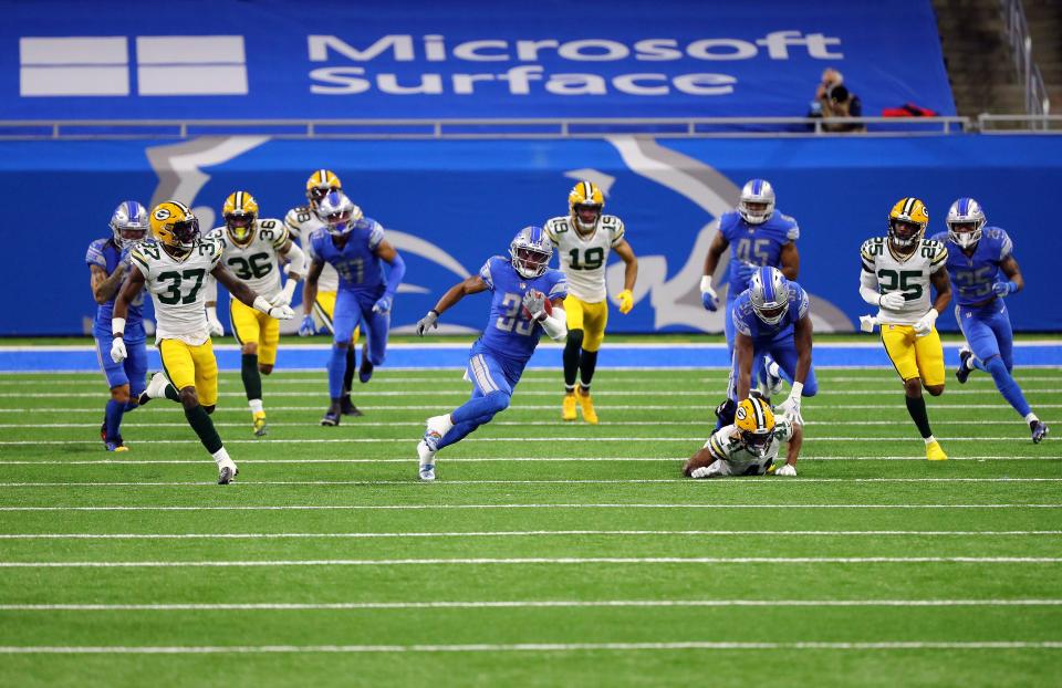 Jamal Agnew (39) of the Detroit Lions returns a kickoff during the fourth quarter against the Green Bay Packers at Ford Field on Dec. 13, 2020, in Detroit, Michigan.