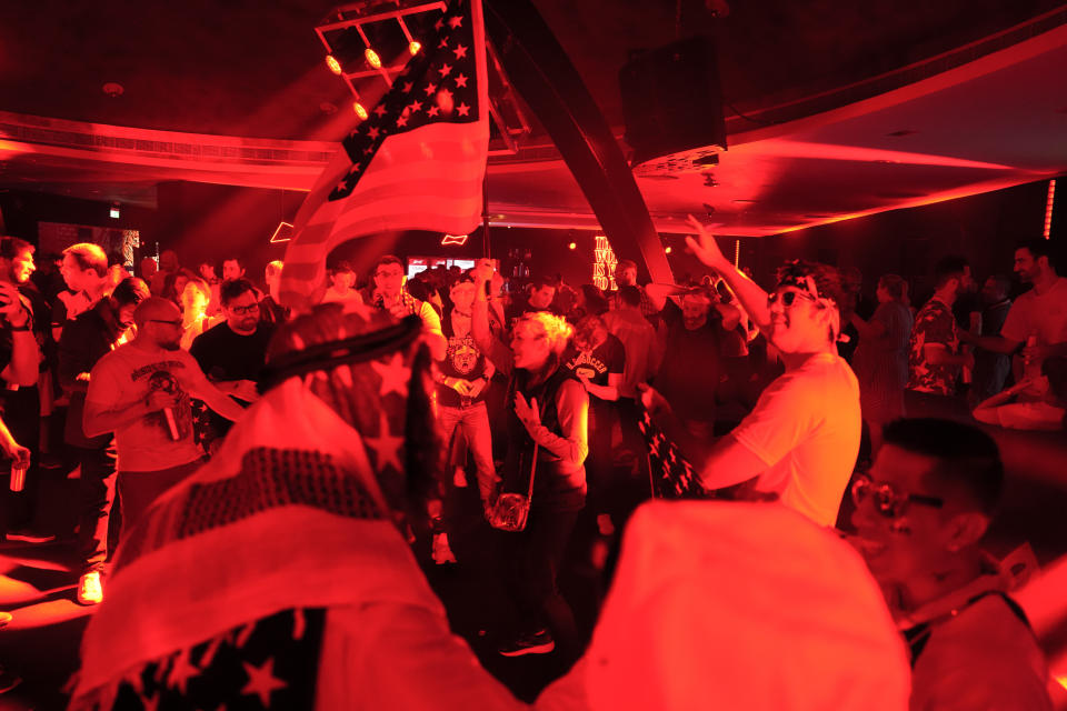People dance during an official U.S. Soccer fan party at the Budweiser World Club ahead of a FIFA World Cup group B soccer match between the United States and Wales, in Doha, Sunday, Nov. 20, 2022. (AP Photo/Ashley Landis)