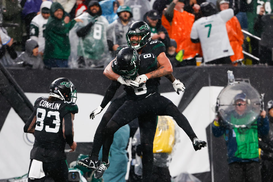 EAST RUTHERFORD, NJ - NOVEMBER 27:  New York Jets wide receiver Elijah Moore (8) celebrates with New York Jets tight end C.J. Uzomah (87) after scoring a touchdown during  the National Football League game between the New York Jets and the Chicago Bears on November 27, 2022 at MetLife Stadium in East Rutherford, New Jersey.   (Photo by Rich Graessle/Icon Sportswire via Getty Images)