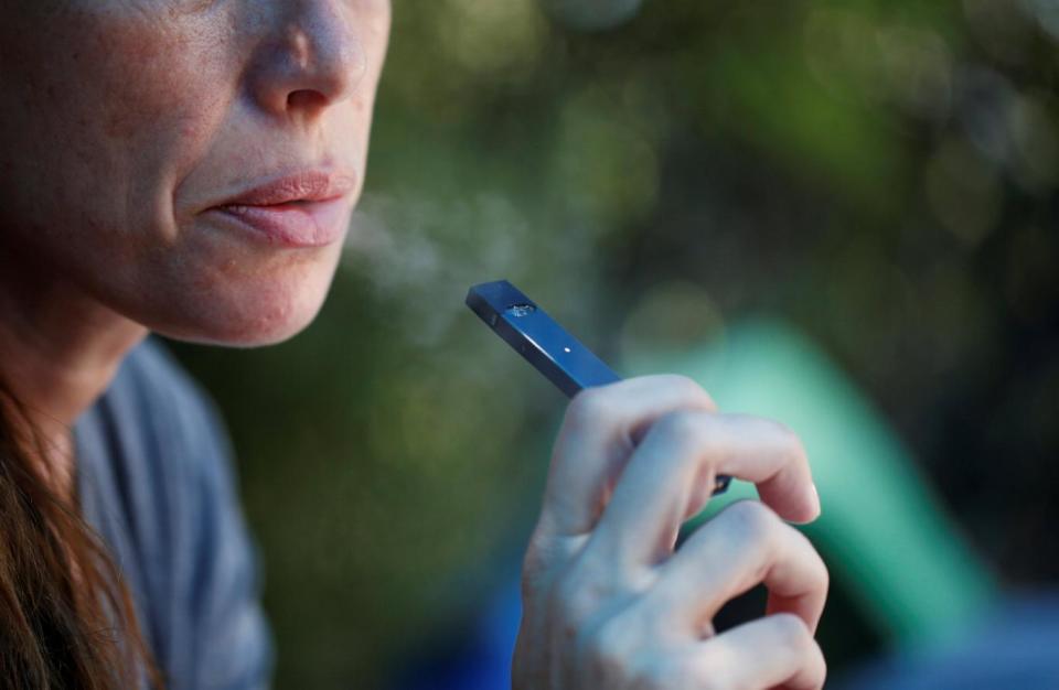 Woman smokes a Juul e-cigarette (REUTERS)