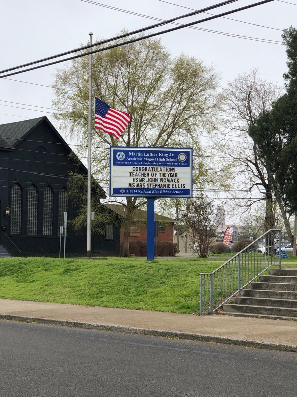 A flag flies at half staff outside Martin Luther King Jr. Academic Magnet School on April 3, 2023.