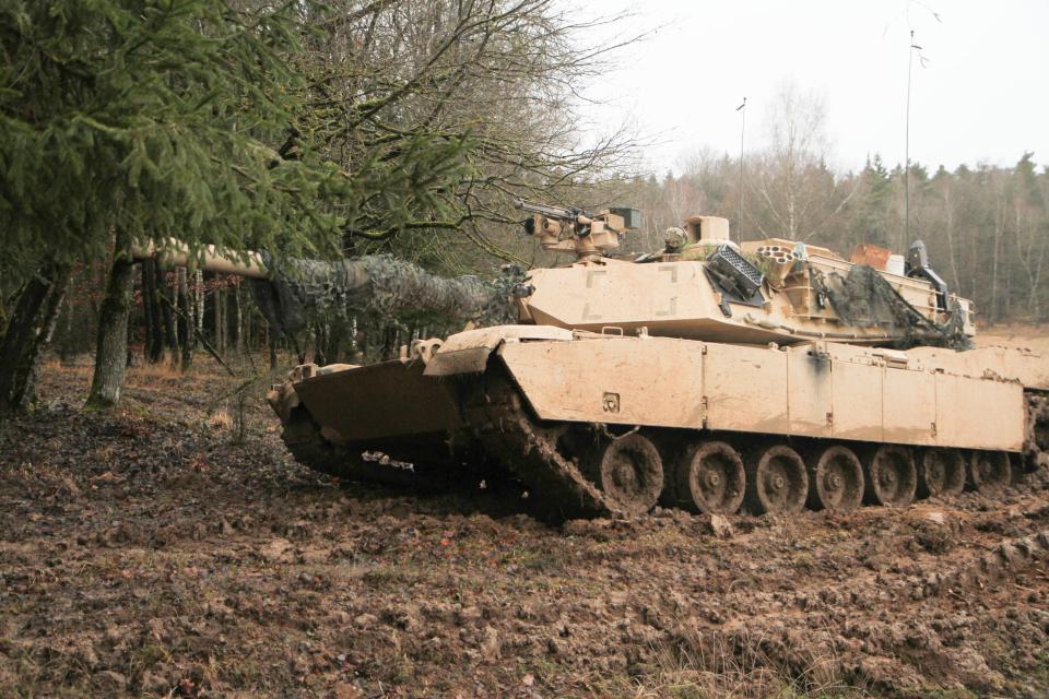 An Abrams tank from 1st battalion, 8th Cavalry Regiment, drives into the woods during Combined Resolve XIII (CBRXIII) at the Joint Multinational Readiness Center Hohenfels, Germany, on Feb. 02, 2002.