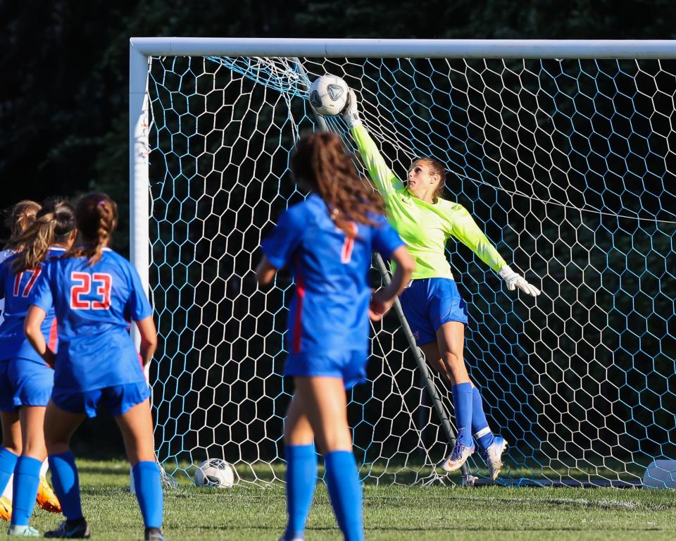 Winnacunnet goalie Kate Gagne leaps to deflect an Exeter shot during Friday's Division I girls soccer match in Hampton. Exeter won 2-0.