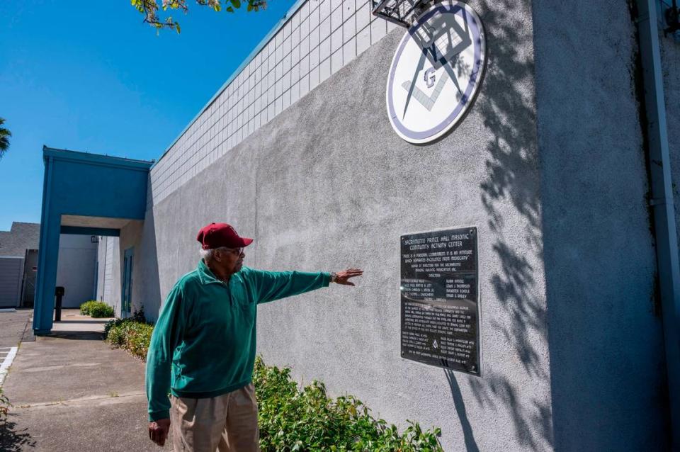 George Blue shows a building placard outside the Sacramento Prince Hall Masonic Community Activity Center on Saturday, April 1, 2023. The 86-year-old leader of the Sacramento chapter of the Prince Hall Freemasons, a Black branch of the fraternal organization, has found himself in the position of trying to retain his hall’s charitable-purpose tax exemption