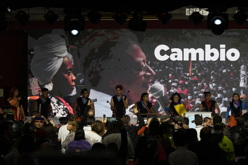 Musicians perform before supporters of Gustavo Petro, presidential candidate with the Historical Pact coalition, on election night in Bogota, Colombia, Sunday, May 29, 2022. Petro will advance to a runoff contest in June after none of the six candidates in Sunday's first round got half the vote. The Spanish word "Change" is the start of the phrase "Change for life." (AP Photo/Fernando Vergara)