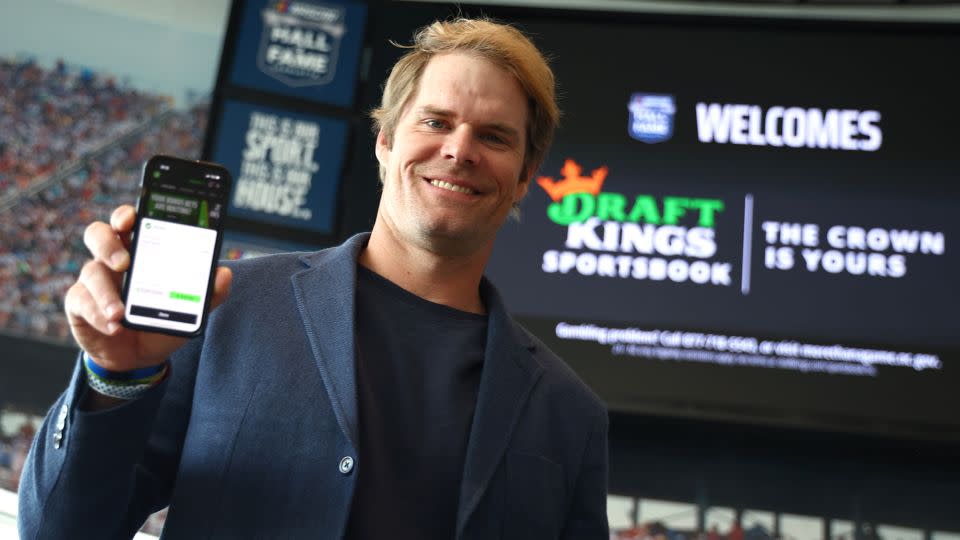 Former NFL tight end and sportscaster Greg Olsen shows the first bet placed during the DraftKings First Bet in North Carolina at NASCAR Hall of Fame in March. - Jared C. Tilton/Getty Images