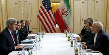 U.S. Secretary of State John Kerry (L) meets with Iranian Foreign Minister Mohammad Javad Zarif on what is expected to be "implementation day," the day the International Atomic Energy Agency (IAEA) verifies that Iran has met all conditions under the nuclear deal, in Vienna January 16, 2016. REUTERS/Kevin Lamarque