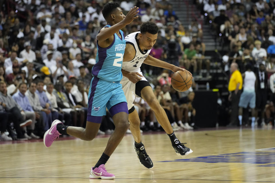 San Antonio Spurs' Victor Wembanyama drives against Charlotte Hornets' Brandon Miller during the first half of an NBA summer league basketball game Friday, July 7, 2023, in Las Vegas. (AP Photo/John Locher)