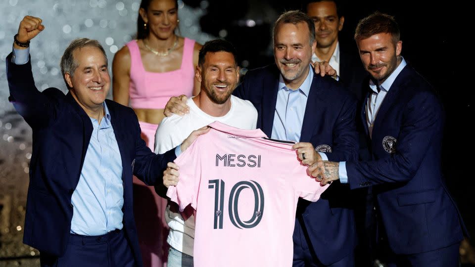 Messi is presented with an Inter Miami jersey alongside club owners Jorge Mas, Jose R. Mas and David Beckham. - Marco Bello/Reuters