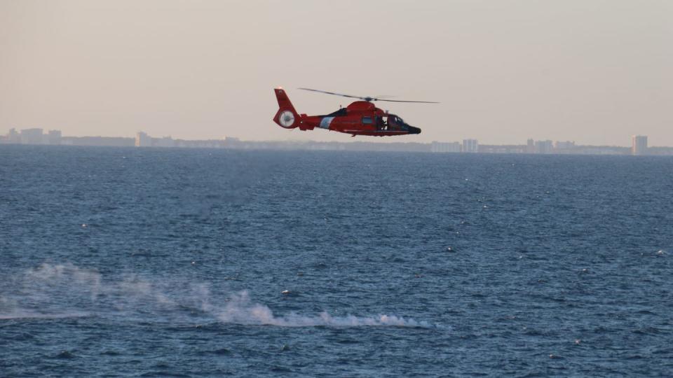 A Coast Guard helicopter flies over a debris field during recovery efforts of a high-altitude surveillance balloon Feb. 4, 2023. (Lt. j.g. Jerry Ireland/Navy)