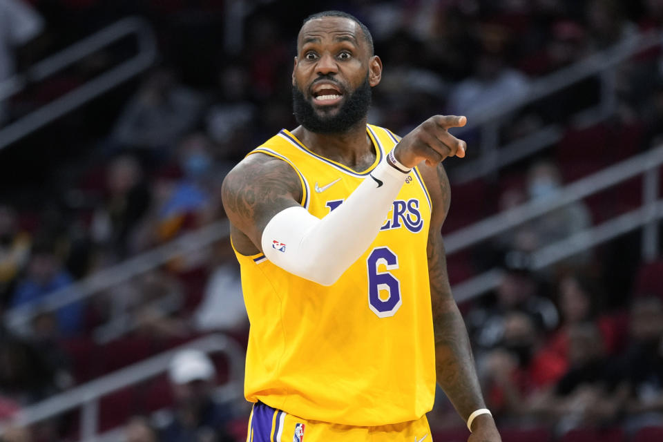 Los Angeles Lakers forward LeBron James talks to teammates during the first half of an NBA basketball game against the Houston Rockets, Tuesday, Dec. 28, 2021, in Houston. (AP Photo/Eric Christian Smith)