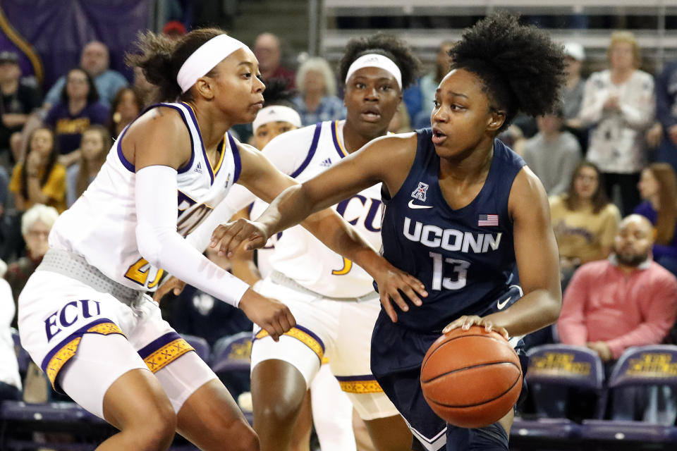 Connecticut's Christyn Williams, right, drives the ball around East Carolina's Ryann Evans, left, during the first half of an NCAA college basketball game, Saturday, Jan. 25, 2020 in Greenville, N.C. (AP Photo/Karl B DeBlaker)